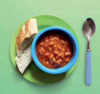 bowl of baked beans with a french stick roll on the side