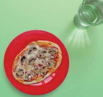 Image of a pizza made with a pitta bread with mushrooms on top. 