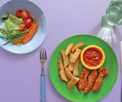 Fish fingers on a plate with a side salad and chips. There is a glass of water and cutlery on the table.