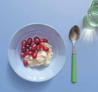 Image of frozen yoghurt in a bowl topped with grapes