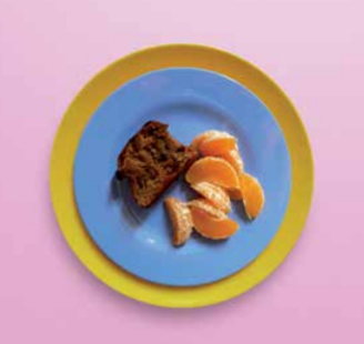Image of malt loaf on a plate with a satsuma that has been peeled into segments. 