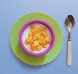 Diced mango on top of a bowl of plain yoghurt