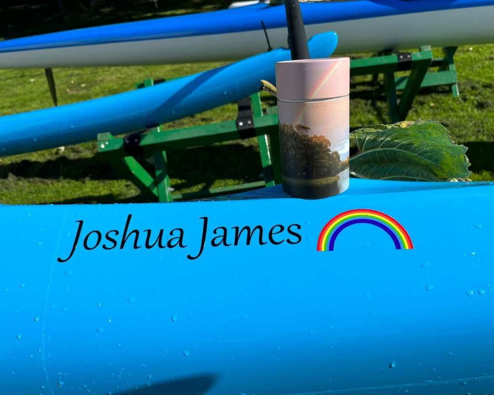 A boat with Joshua James and a rainbow on it