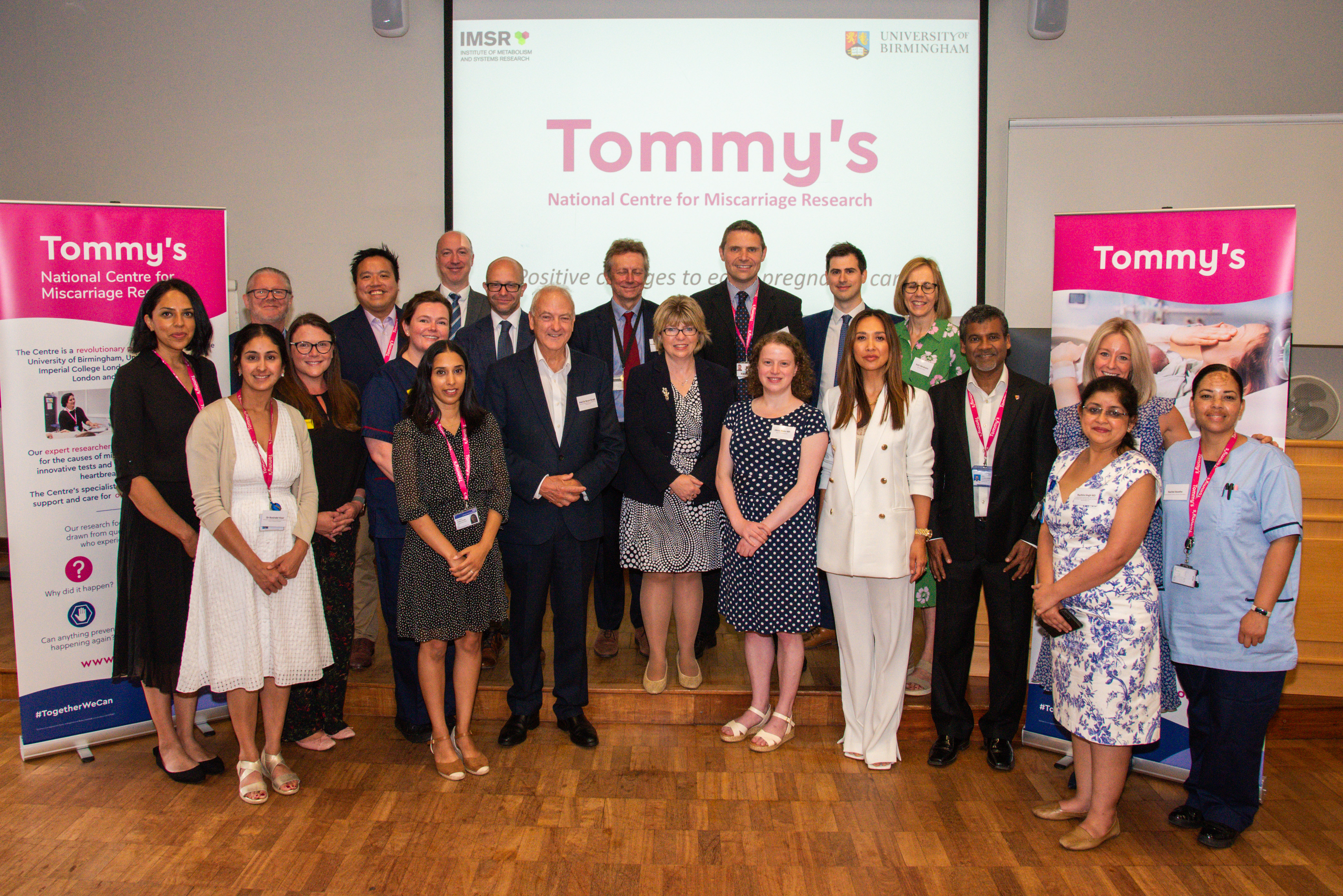 A photo from Maria Caulfield MP's visit to Tommy's National Centre for Miscarriage Research. There are 21 people in the photo smiling at the camera, including our Ambassador Myleene Klass, our CEO Kath Abrahams and Olivia Blake MP.