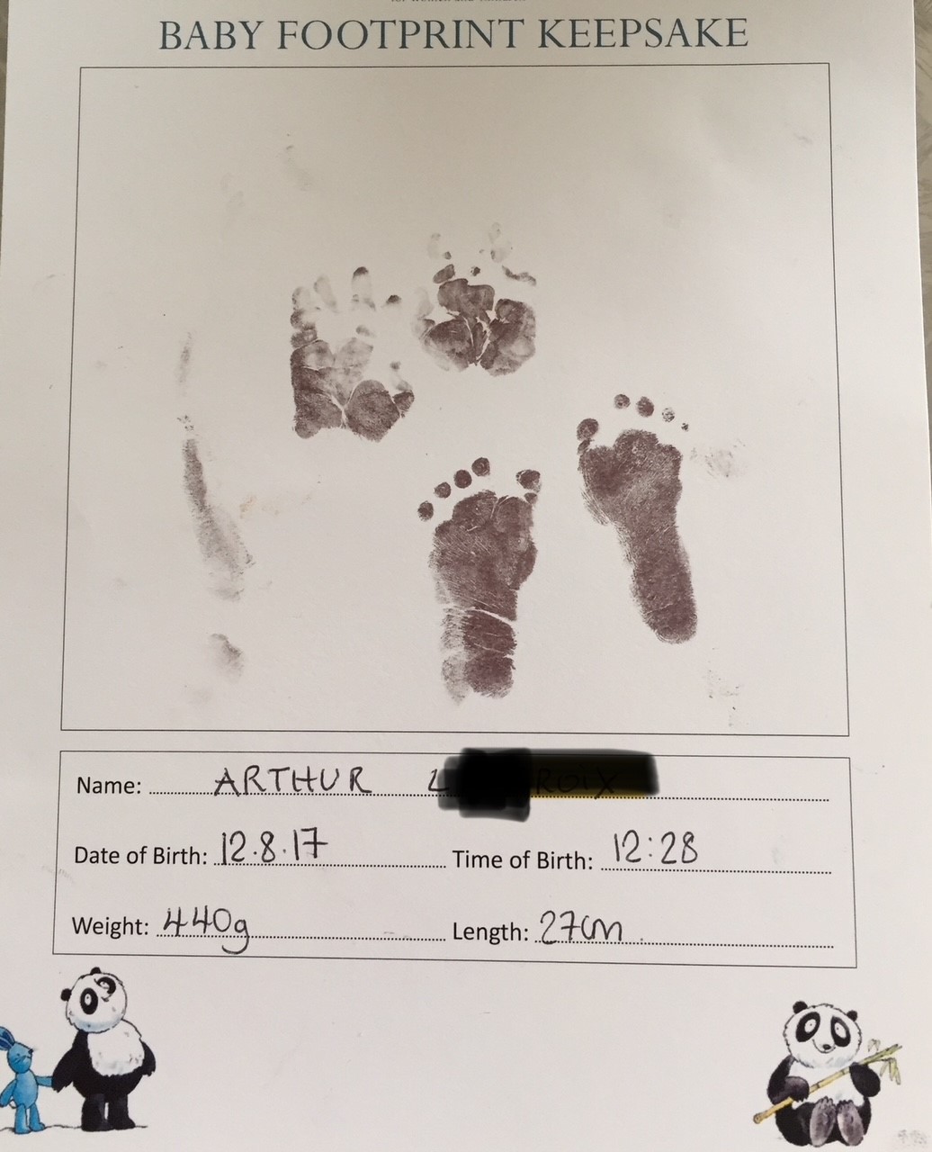Arthur's hand and footprints on a certificate