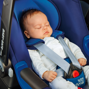 A photo of a baby asleep in a car seat