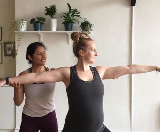 The yoga midwife, supporting a woman with her yoga pose